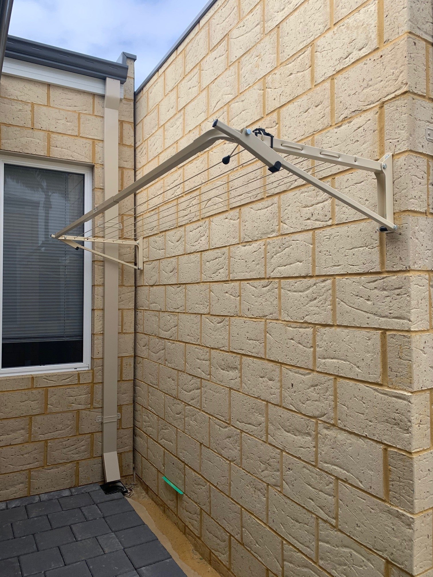 Austral Slenderline 16 Classic Cream Fold Down Clothesline wallmount installed onto Florentine brick-Aussie Clotheslines & Letterboxes