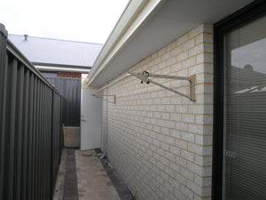 Austral Slenderline 20 Classic Cream Wall mounted on brick wall in narrow space-Aussie Clotheslines & Letterboxes