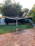 Austral Rotary 51 Clothesline Classic Cream installed into paved area-Aussie Clotheslines & Letterboxes