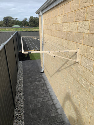 Austral Compact 28 Fold Down Clothesline Classic Cream wallmounted onto Florentine brick lifted position view from above-Aussie Clotheslines & Letterboxes