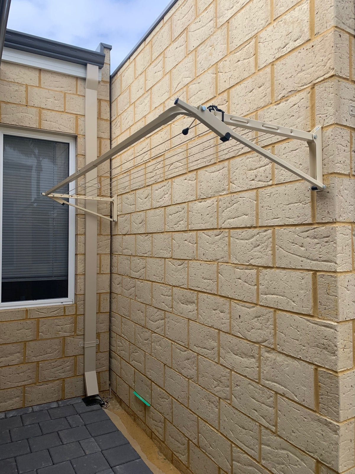 Austral Slenderline 16 Classic Cream Fold Down Clothesline wallmount  installed onto Florentine brick-Aussie Clotheslines & Letterboxes